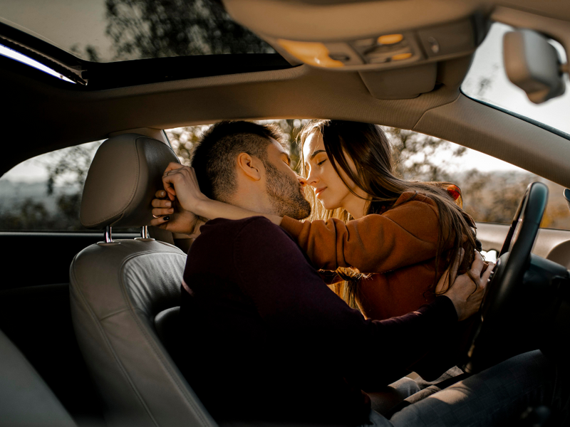 Couple in car kissing each other